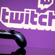 Video game controller in front of purple Twitch logo.